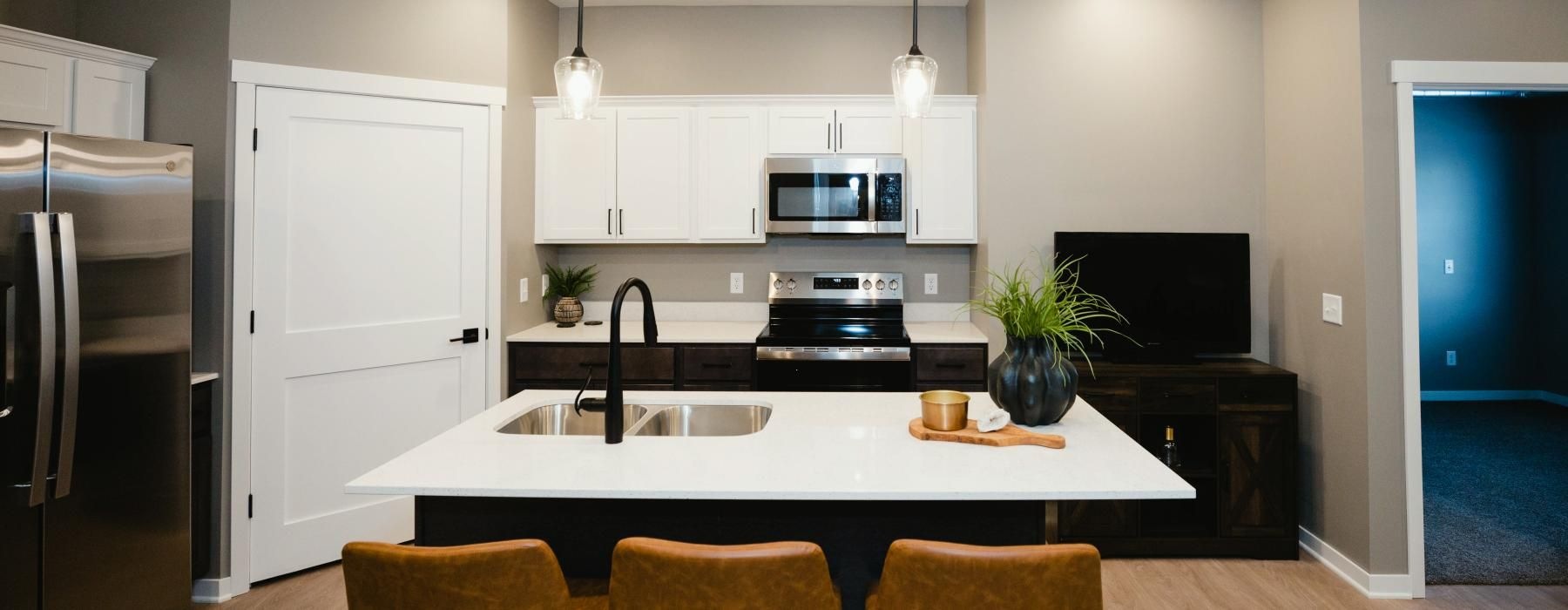 a kitchen with a bar stool and a table